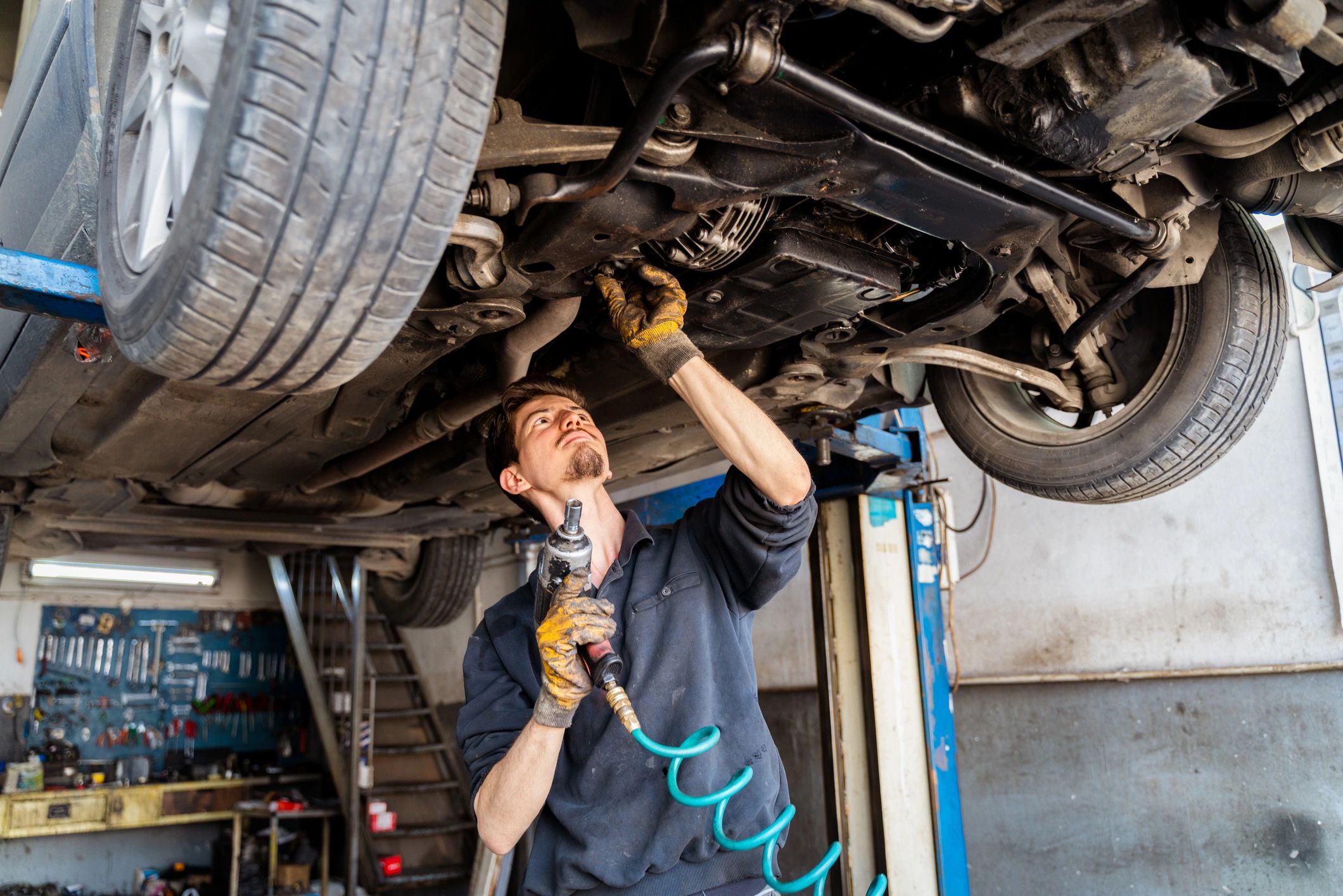 Mechanic standing in an auto repair shop ready to help