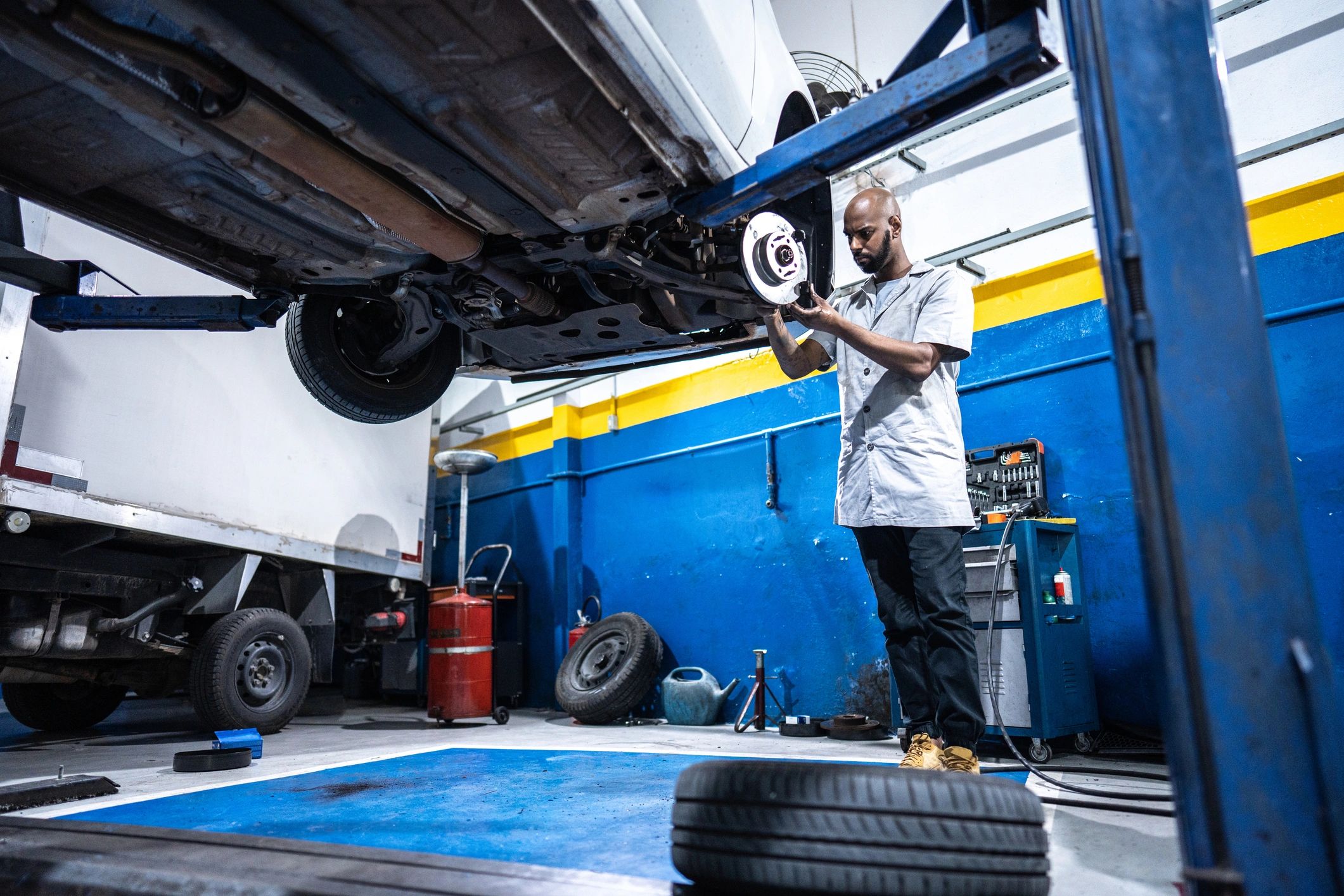 Mechanic servicing a vehicle in an auto repair shop