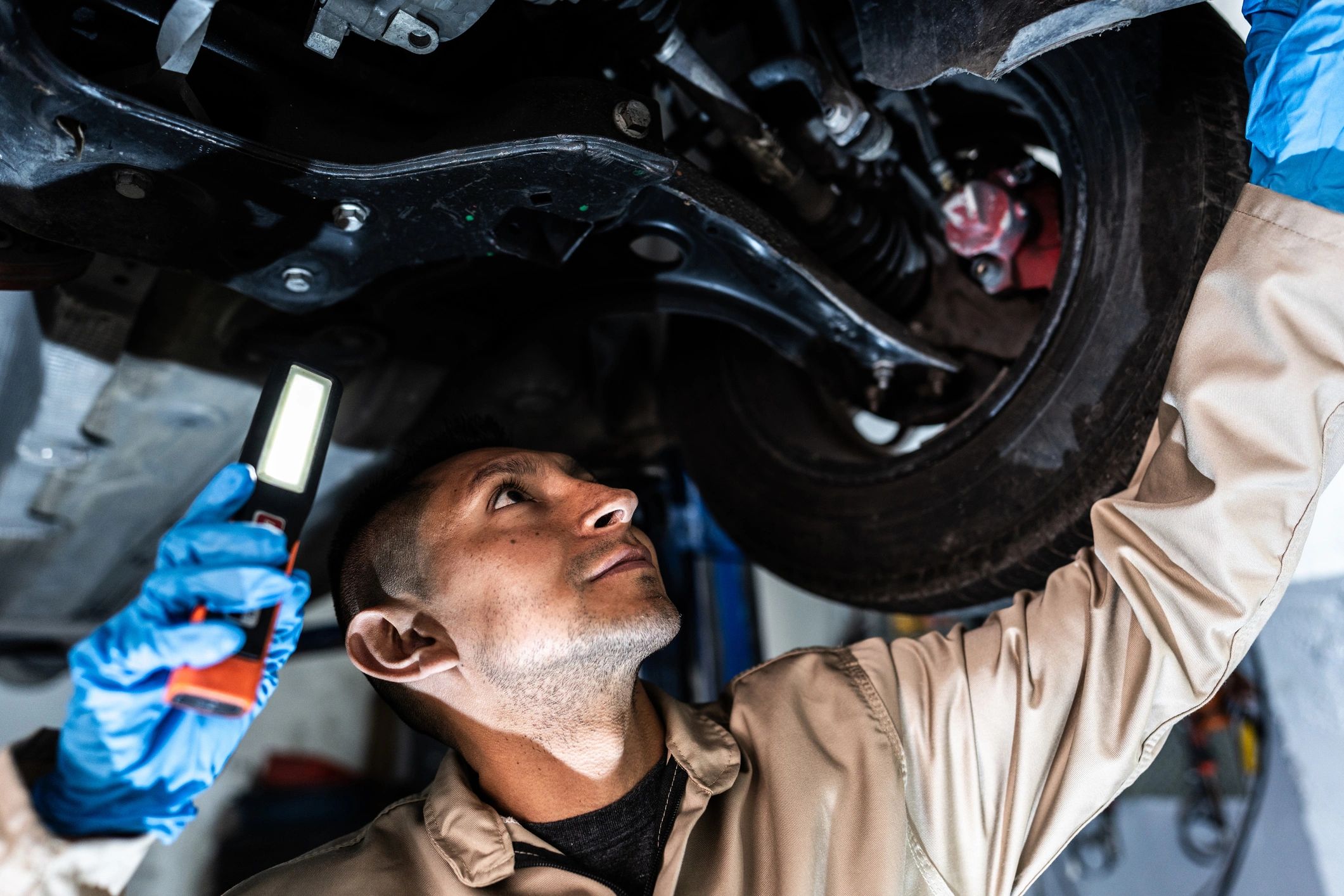 Auto mechanic working on a vehicle in a repair shop