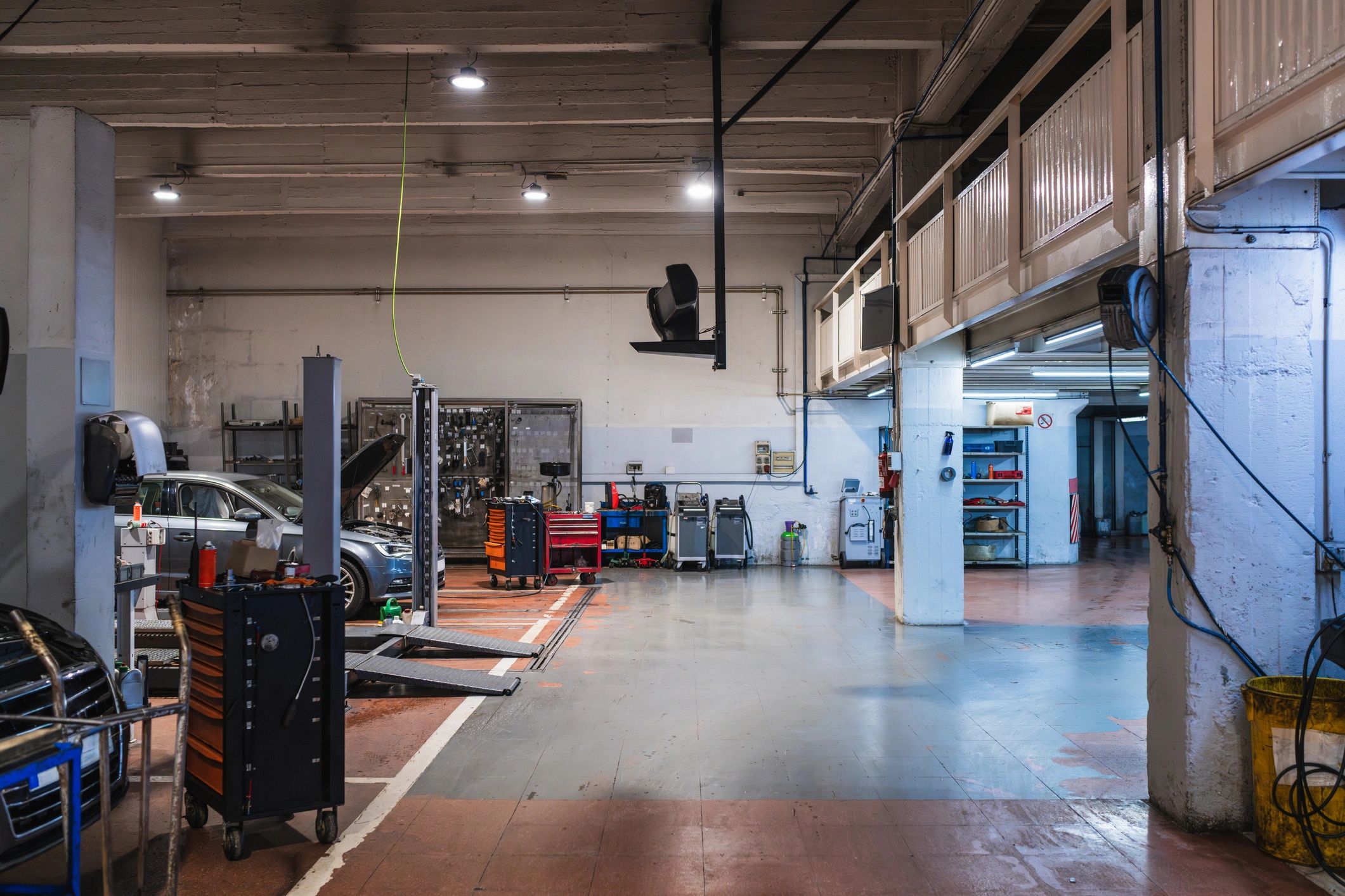 Wide view of a clean auto repair shop with vehicle lifts