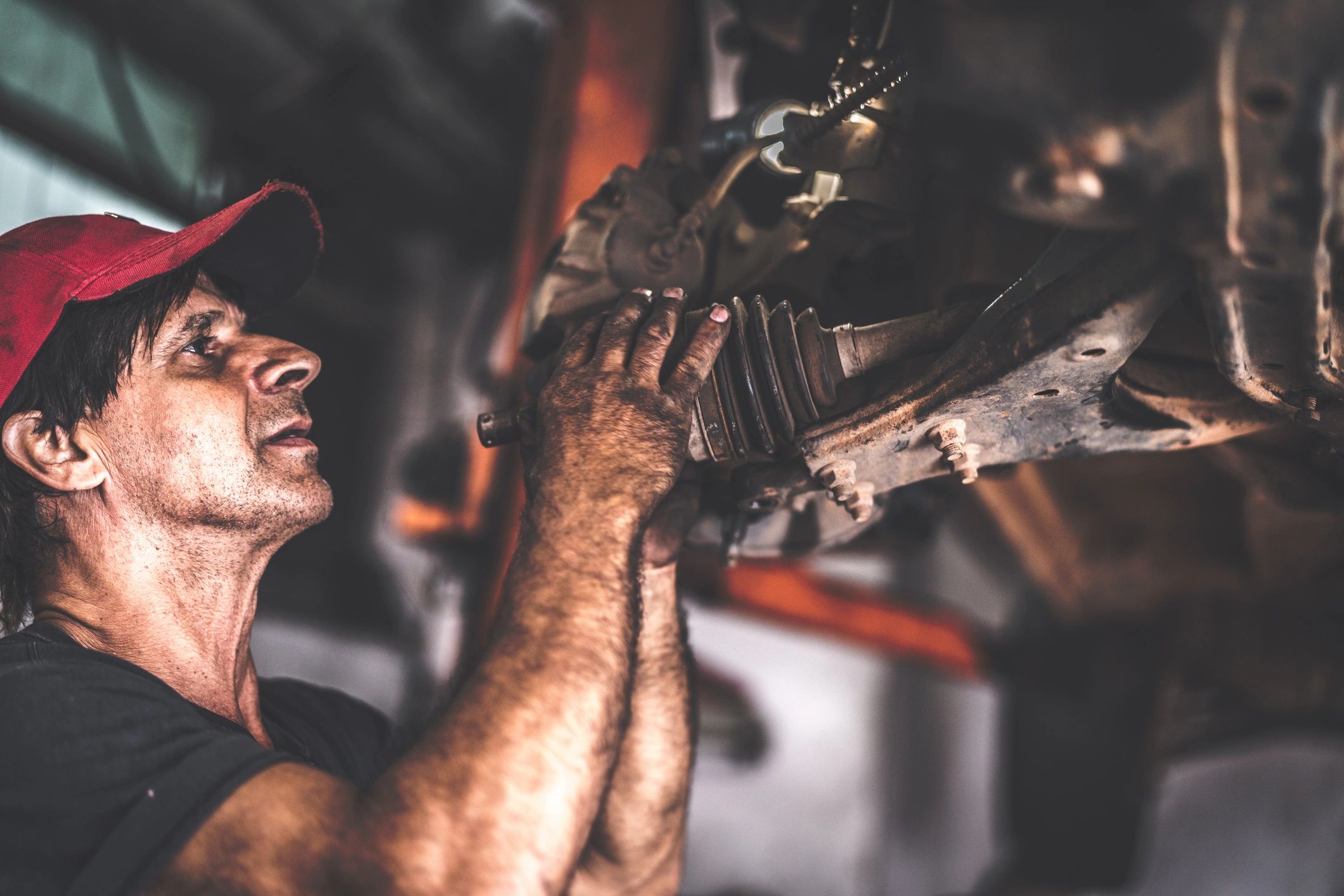 Professional mechanic working on a car in an auto repair shop
